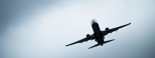 Ett flygplan mot en molnig himmel.